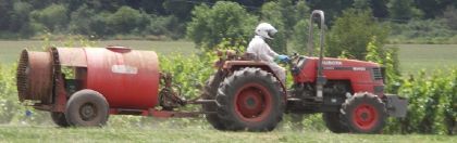 Worker applying pesticide